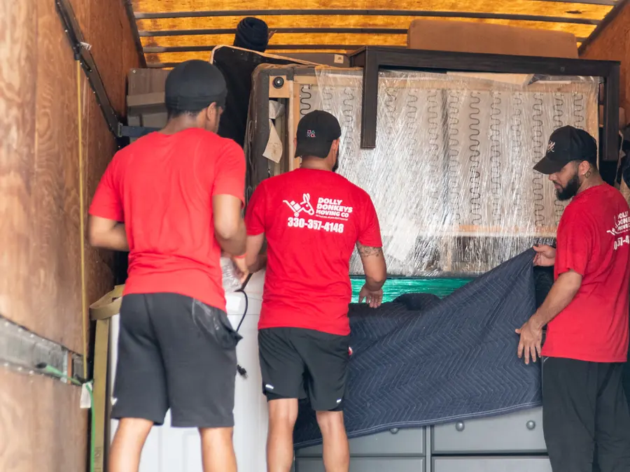 Dolly Donkeys movers padding and wrapping items inside the truck