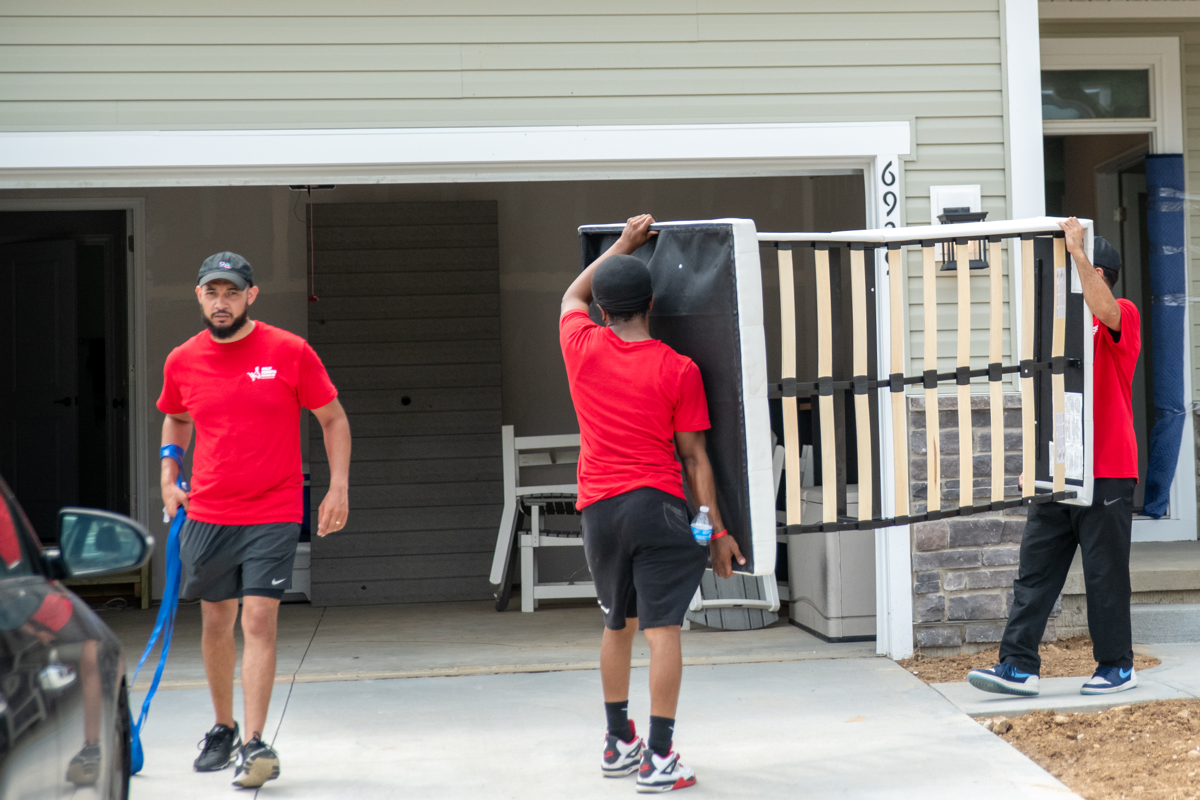 Dolly Donkeys movers carrying furniture into a home in Alliance
