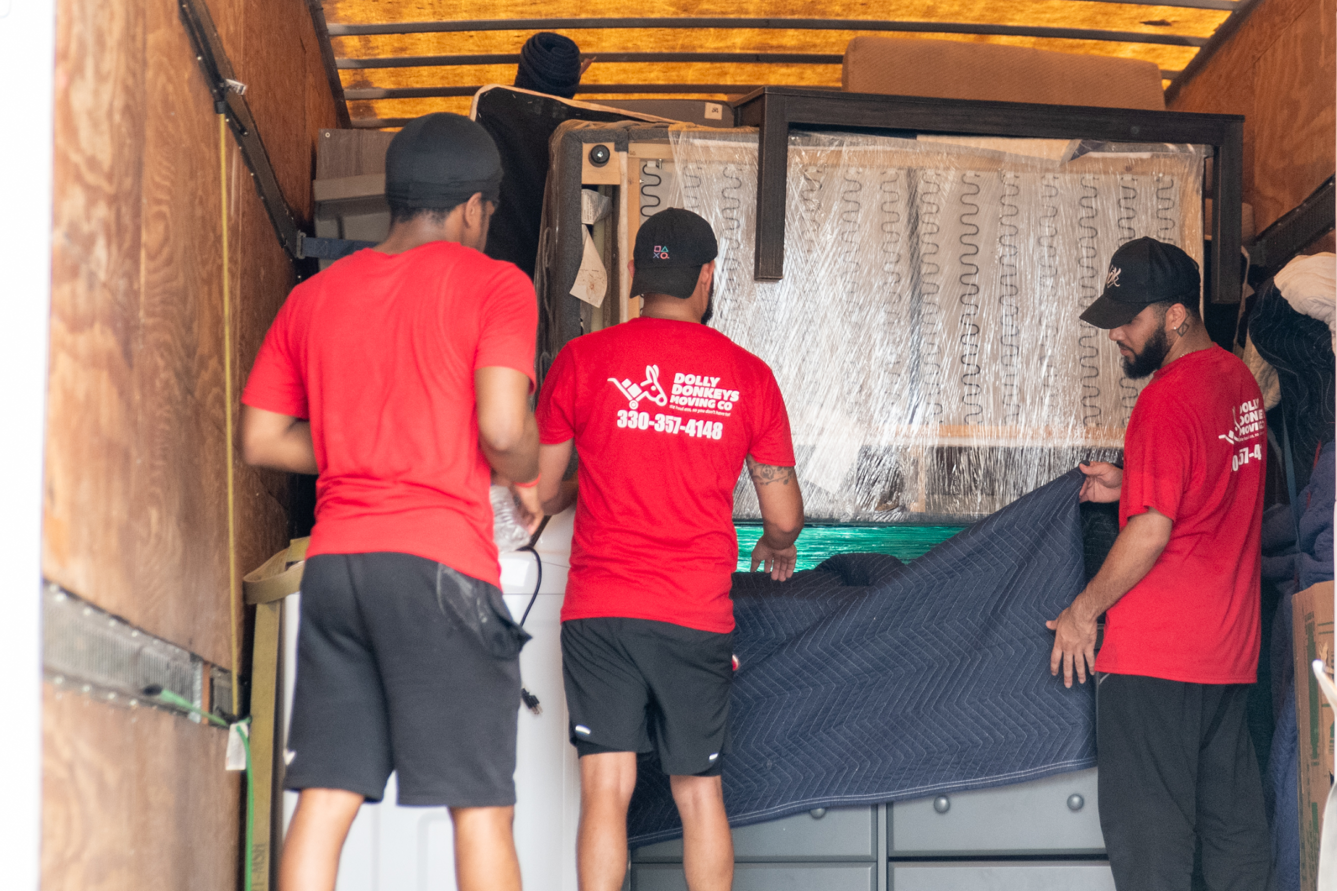 Dolly Donkeys movers wrapping and loading equipment for a commercial move