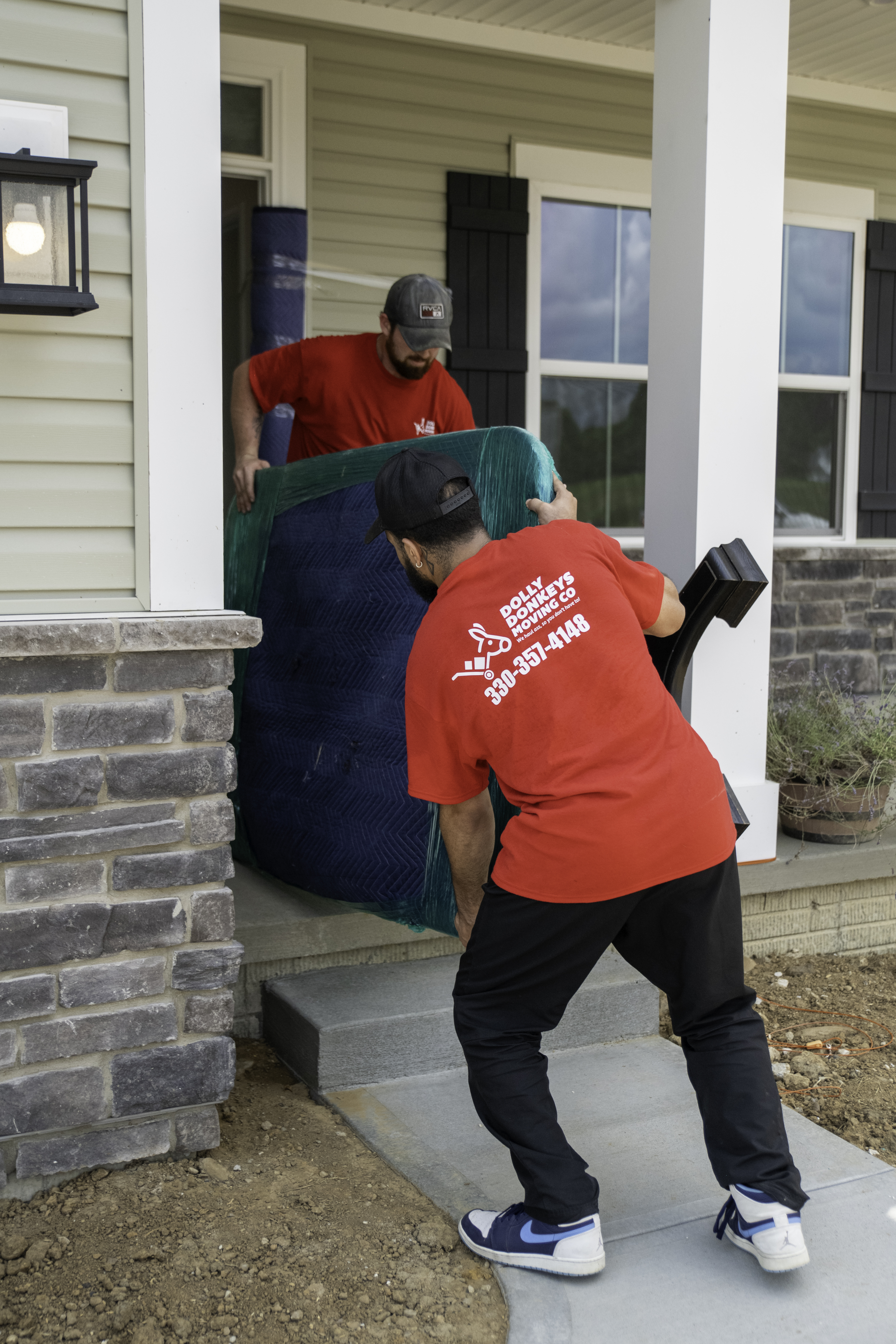 Dolly Donkeys movers delivering a large item into a Canton home